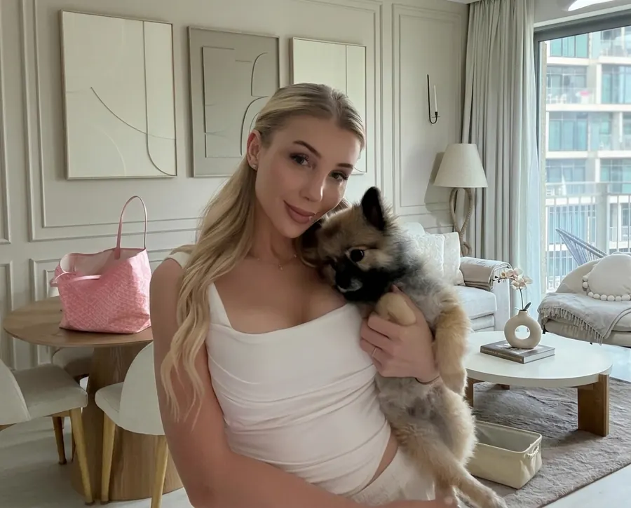 Furs Class Travel founder Kristey holding her Pomeranian Kio after UK → UAE travel